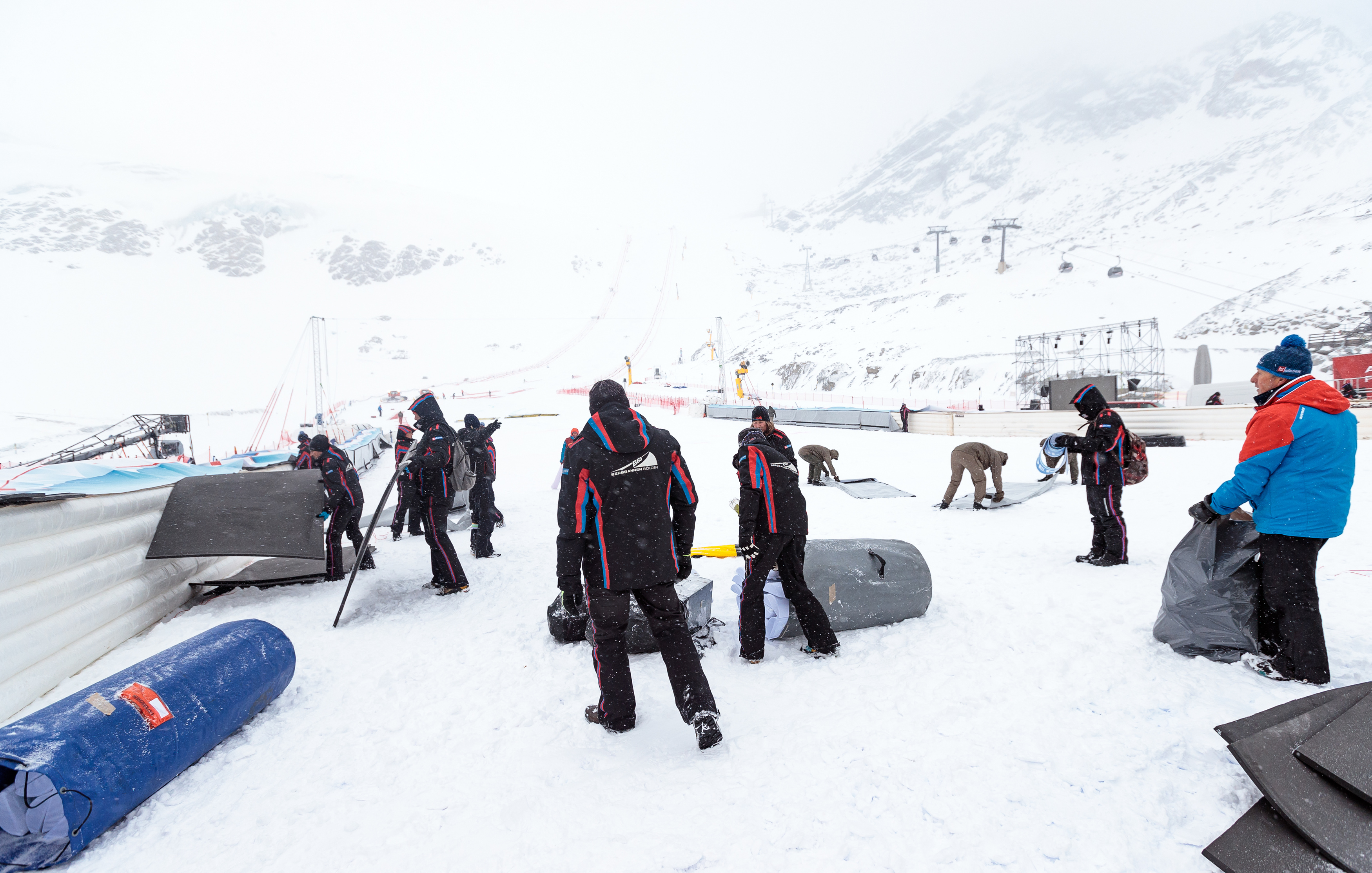 Workers dismantle the venue after the cancellation of the Men's Giant Slalom race at the FIS Alpine Ski World Cup in Soelden, Austria, on October 29, 2017 due to bad weather conditions.