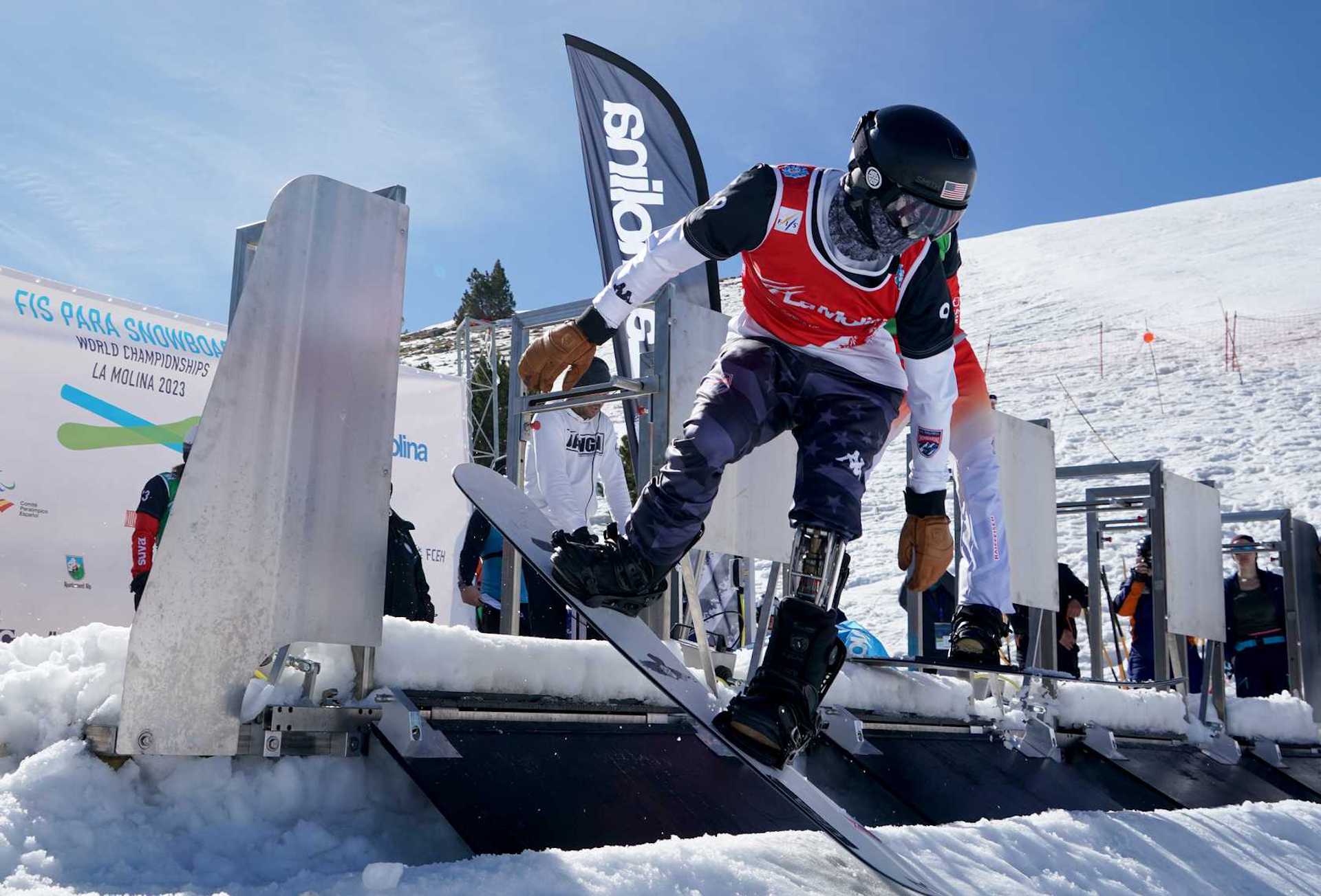 U.S. Para Snowboard athlete pushes out of the gate during a snowboardcross race