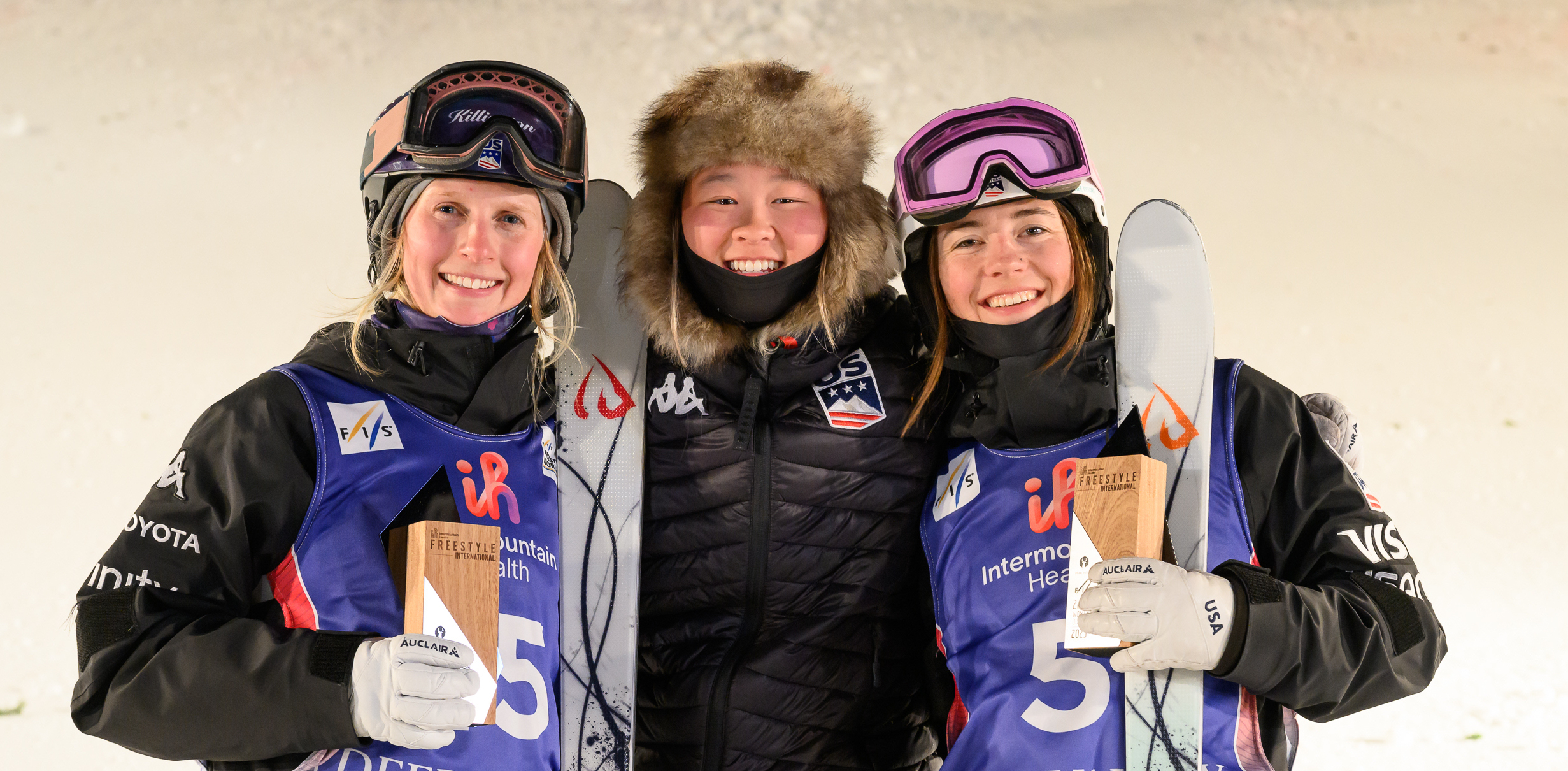 Jaelin Kauf, Kai Owens, and Hannah Soar smile with trophies at the 2023 Deer Valley World Cup