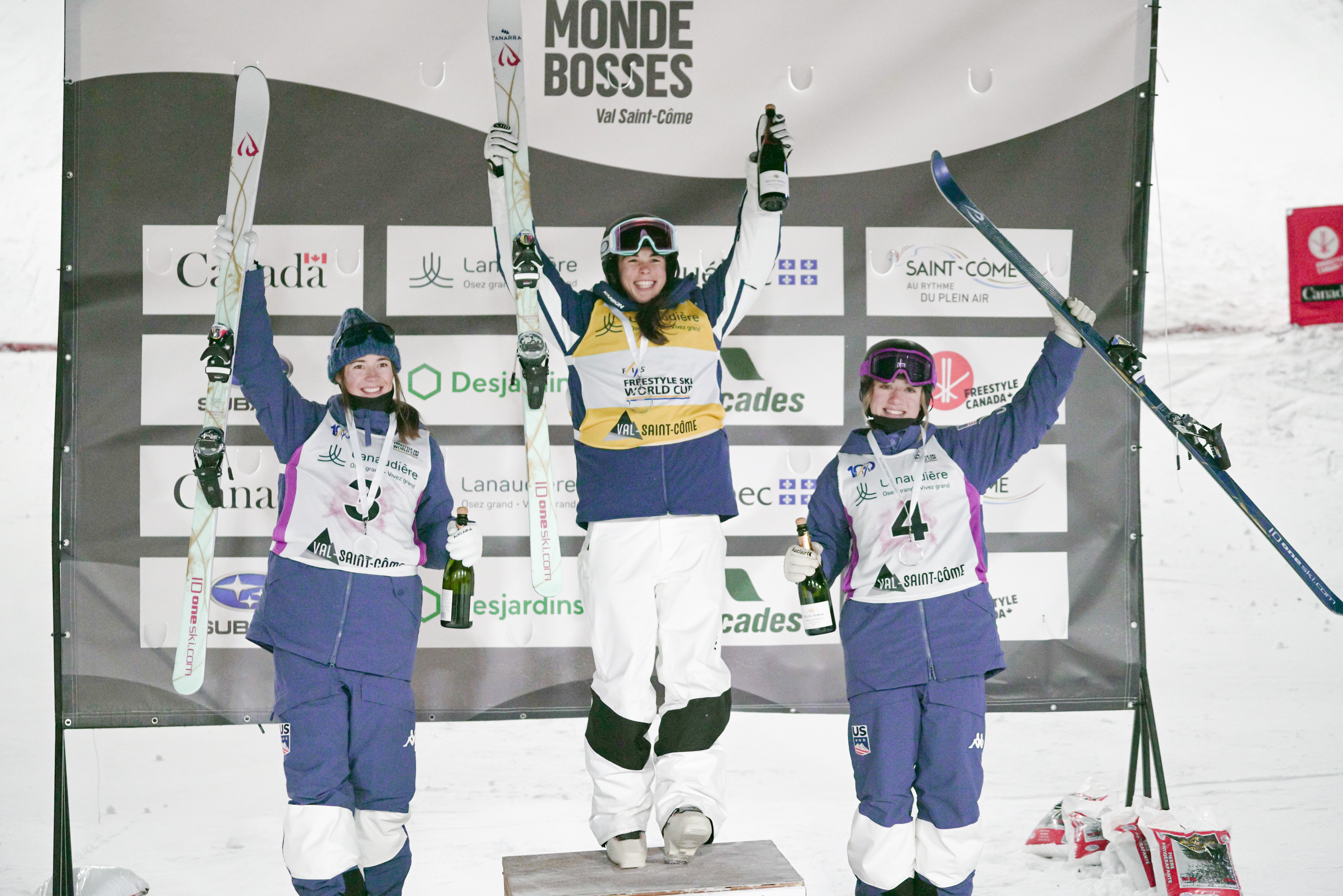 Jaelin Kauf and Olivia Giaccio stand on the dual moguls podium in Val St. Côme, Canada