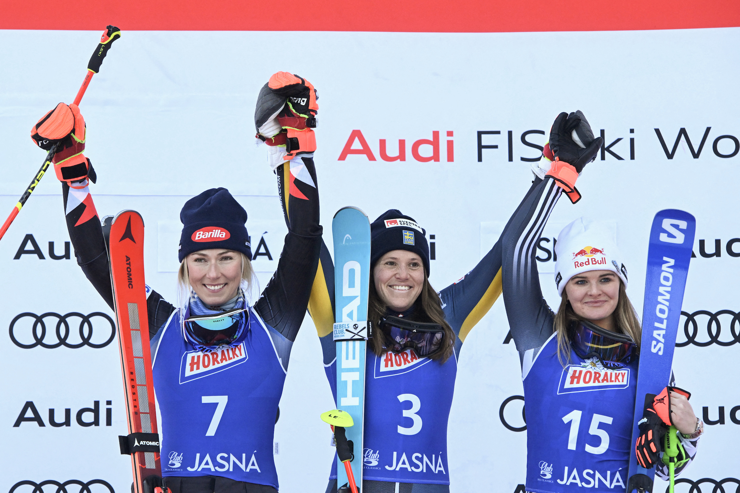 Mikaela Shiffrin stands on the podium with Sweden's Sara Hector and New Zealand's Alice Robinson.