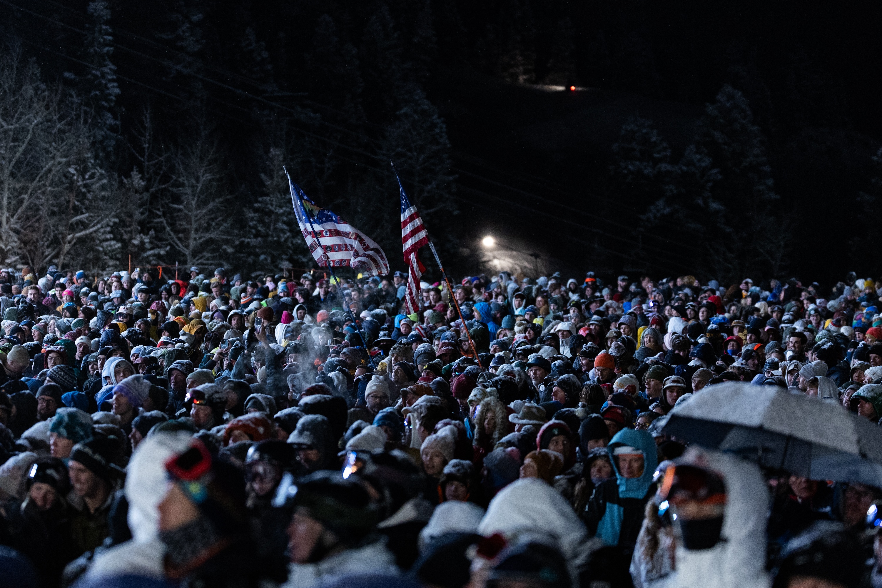 a large crowd gathers at the bottom of the moguls course at Deer Valley Resort