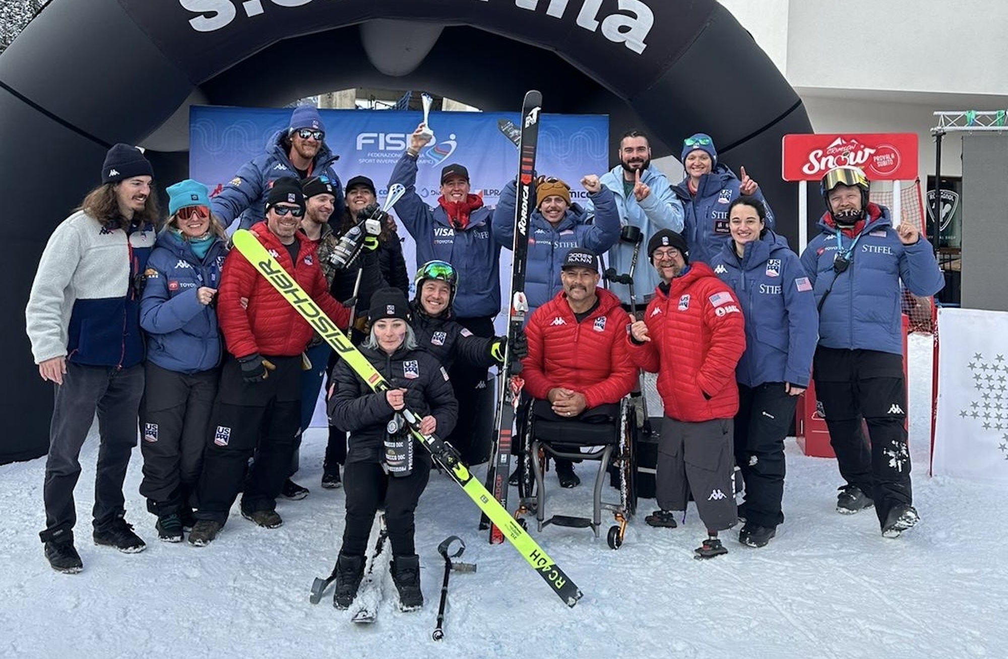 The team celebrating on the podium in Santa Caterina