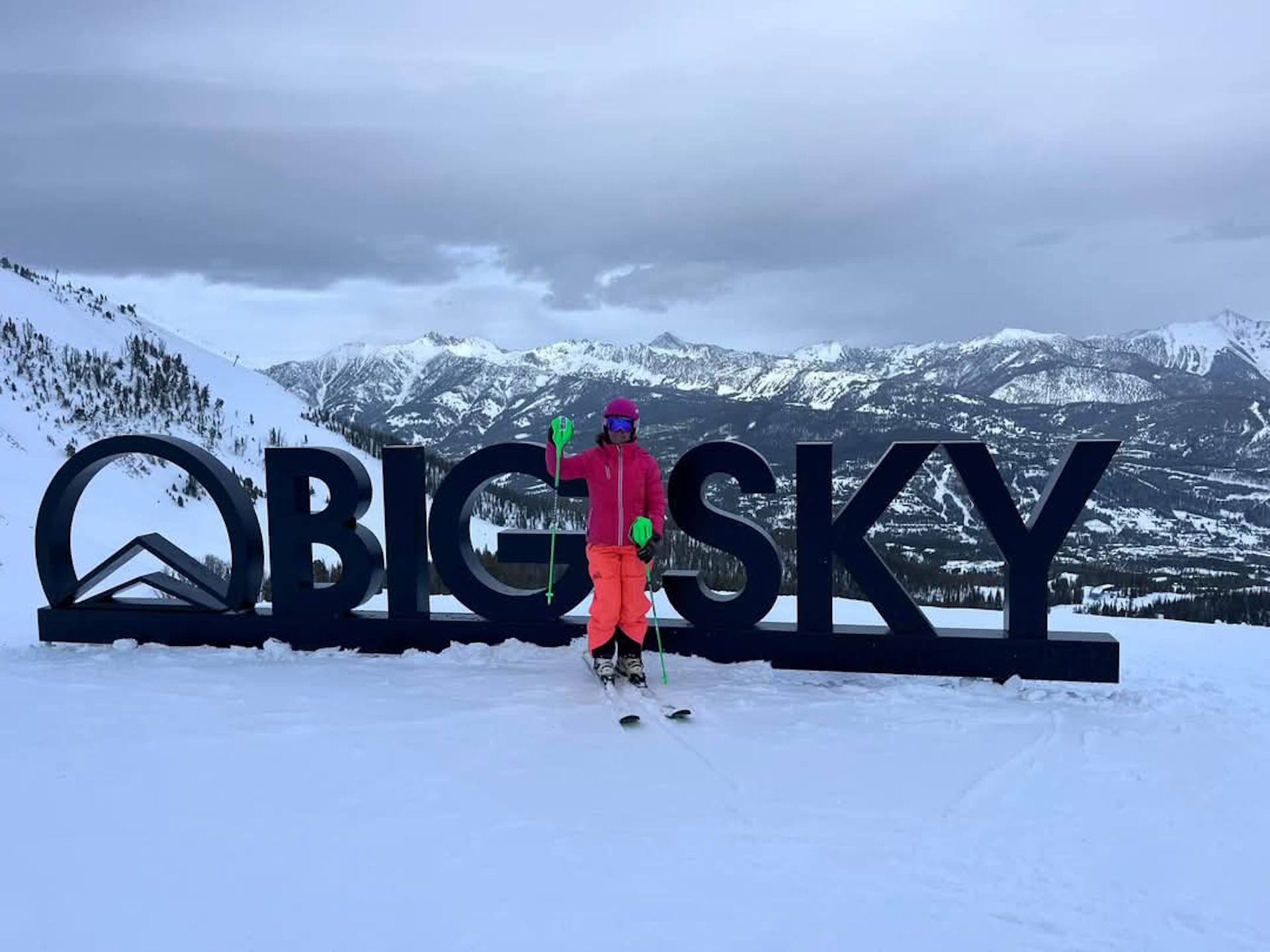 Vera Savage with Big Sky written out behind her in 4ft tall letters and a beautiful mountain view.