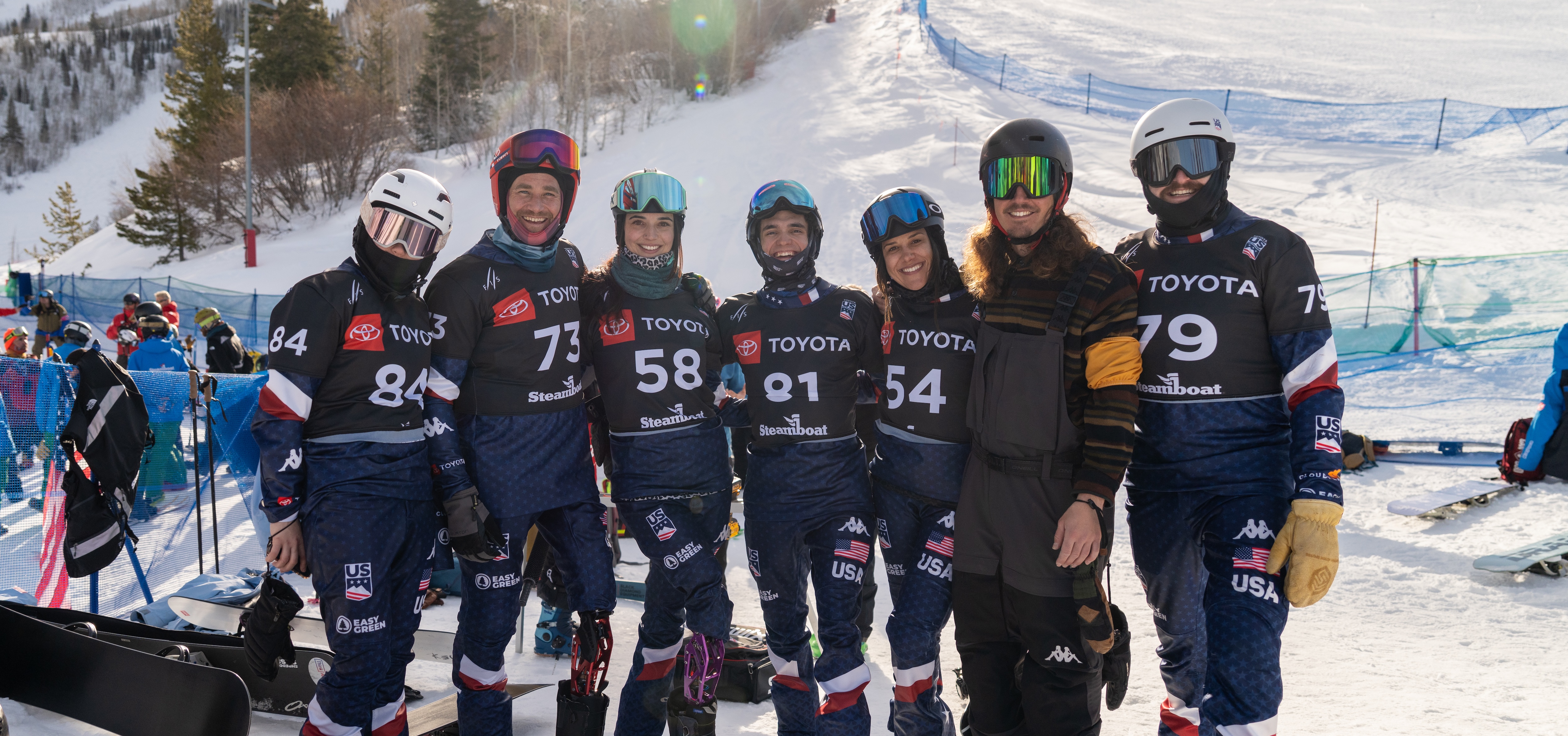 the team posing for a photo at the top of the course in steamboat springs
