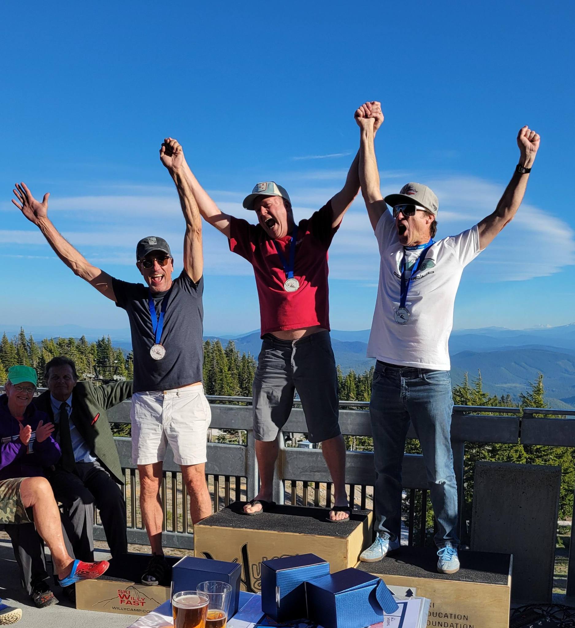 2024 Wy'East Men's Class 7 SL Winners on the Podium with hands in the air