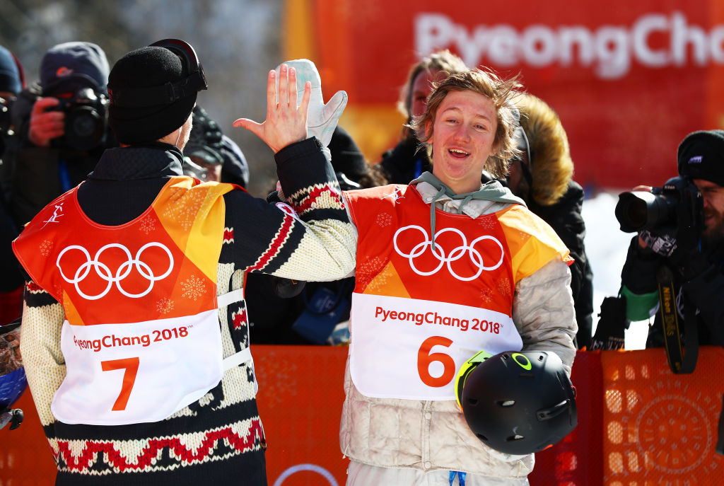 Gold medalist Red Gerard celebrates with silver medalist Max Parrot of Canada during following the snowboard slopestyle final Sunday. (Getty Images - Clive Rose)