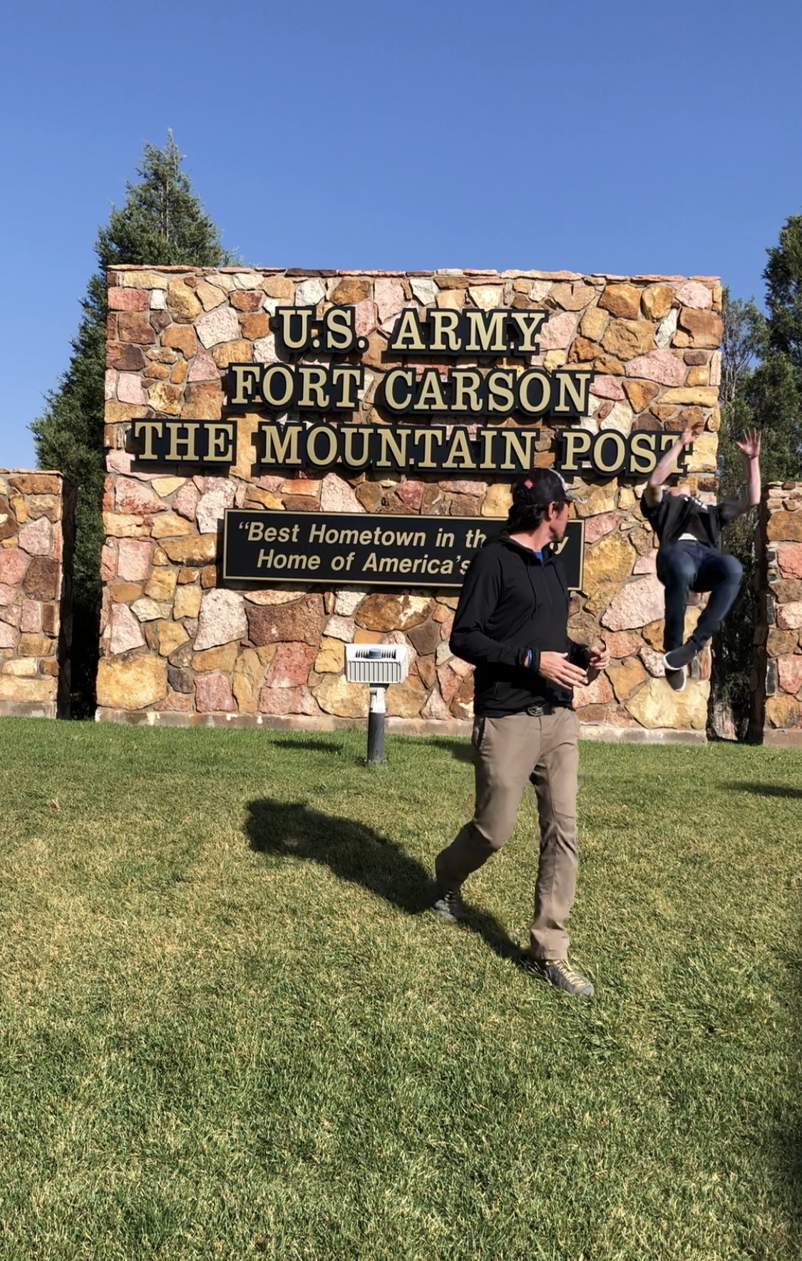 Jason Wolle flipping for the folks at Fort Carson. (U.S. Ski & Snowboard) Jason Wolle backflipping in front of the Fort Carson sign.