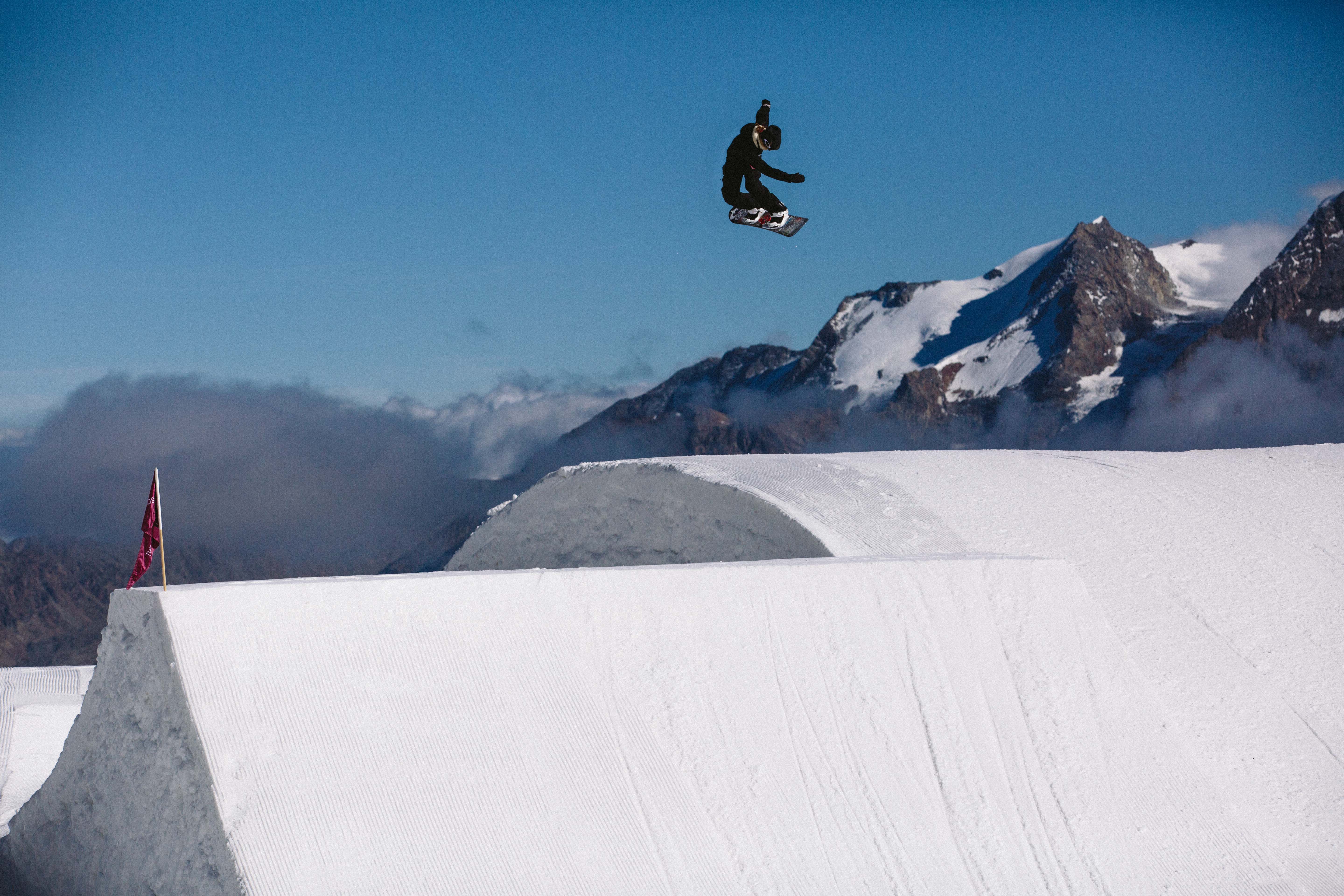 Jamie Anderson throwing a stylish shifty (The Stomping Grounds Park). Jamie Anderson mid air in Switzerland.