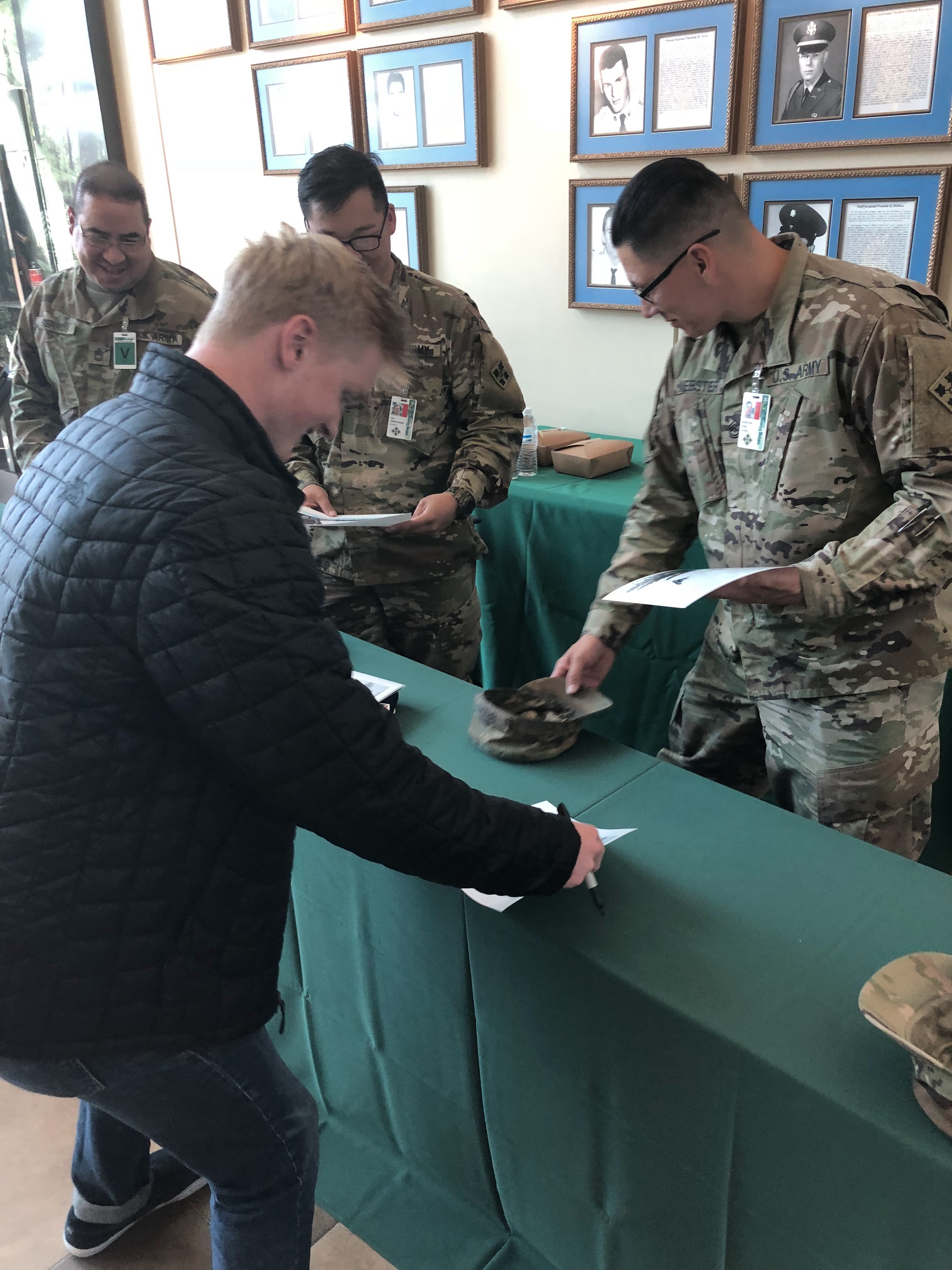 Jason Wolle signing autographs at Fort Carson. (U.S. Ski & Snowboard) Jason Wolle signing posters at Fort Carson for the soldiers
