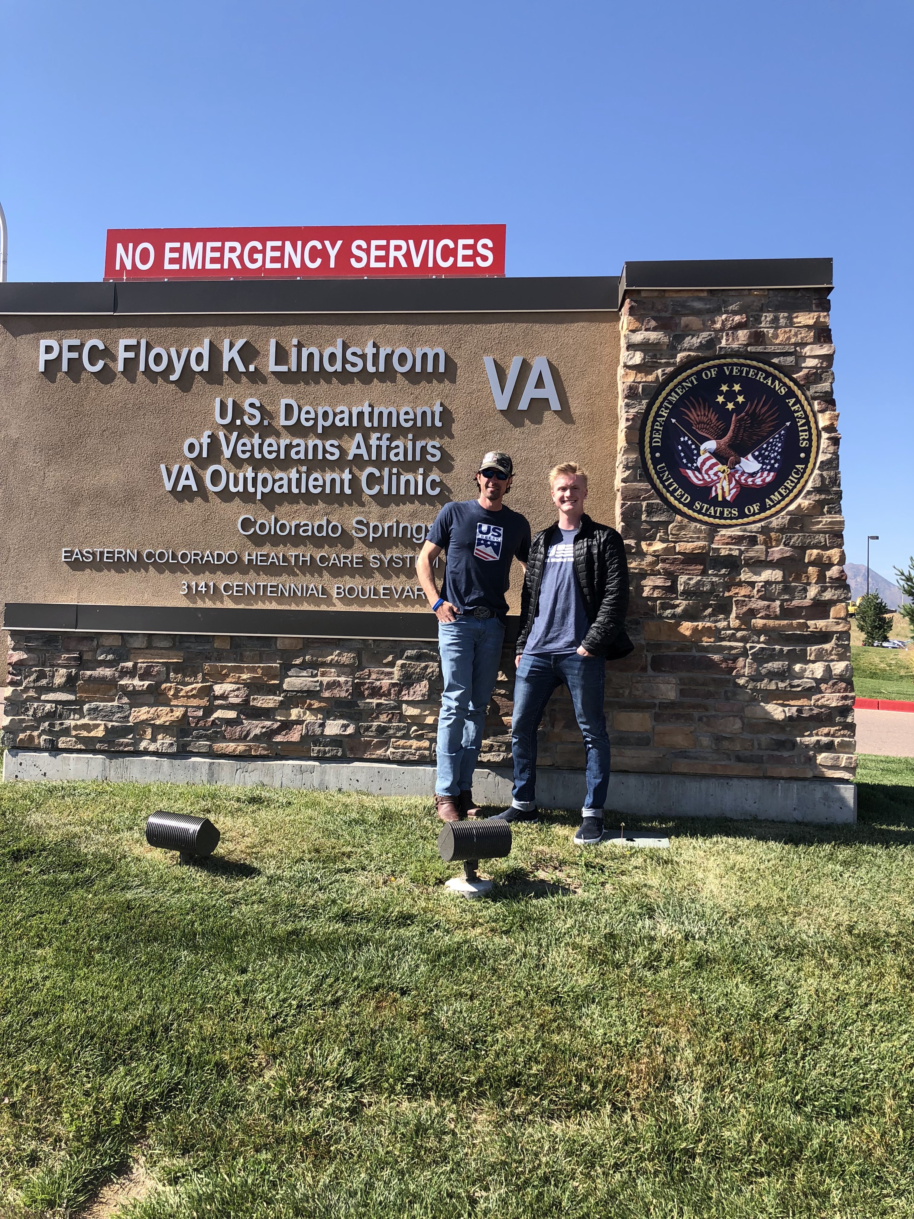 Jason Wolle and Jesse Stewart at the VA in Fort Carson. (U.S. Ski & Snowboard) Jason Wolle and Jesse Stewart in front of VA sign in Fort Carson.