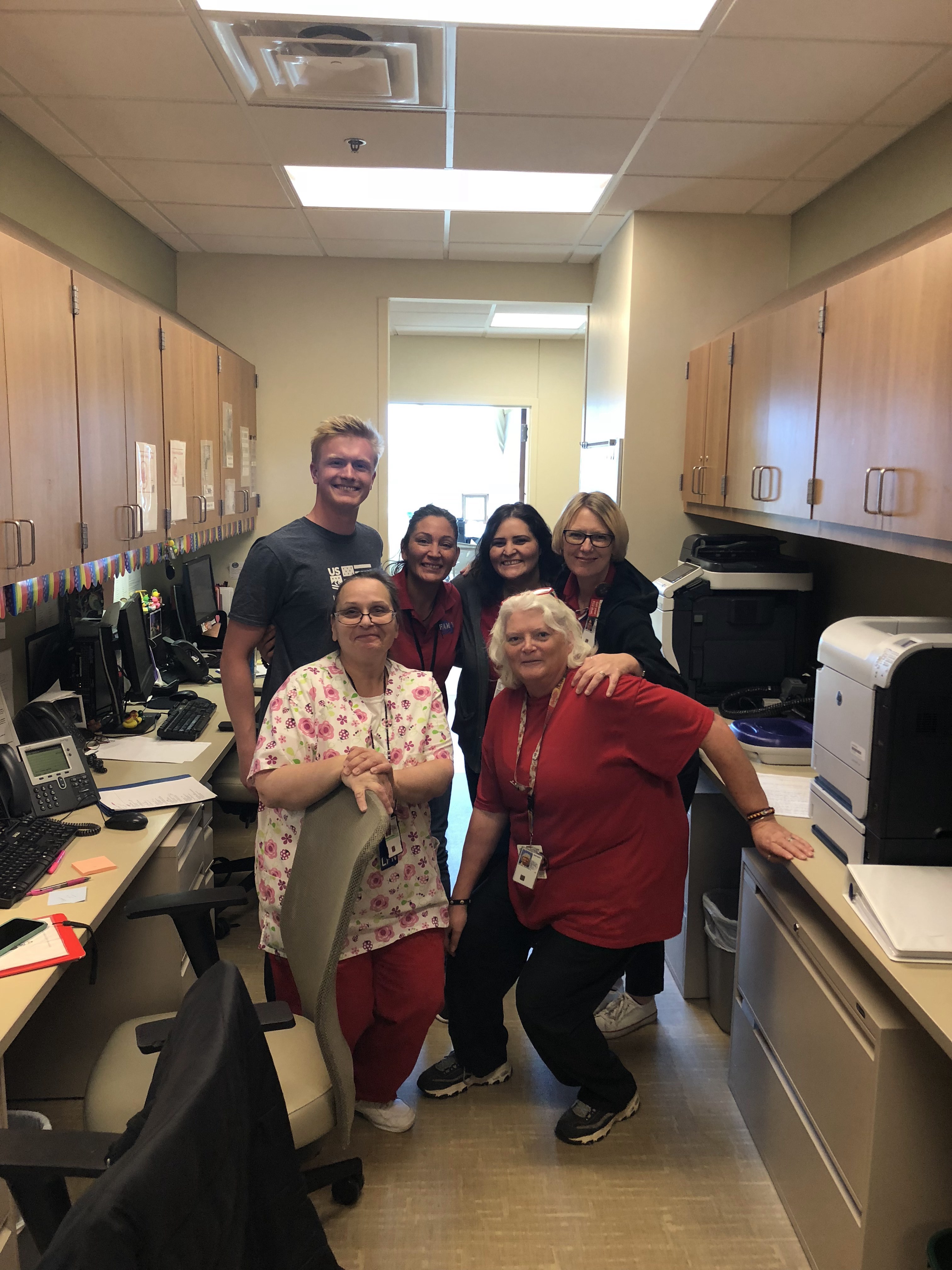 VA staff at Fort Carson were very happy to see Jason Wolle. (U.S. Ski & Snowboard) Jason Wolle with medical staff at VA in Fort Carson.
