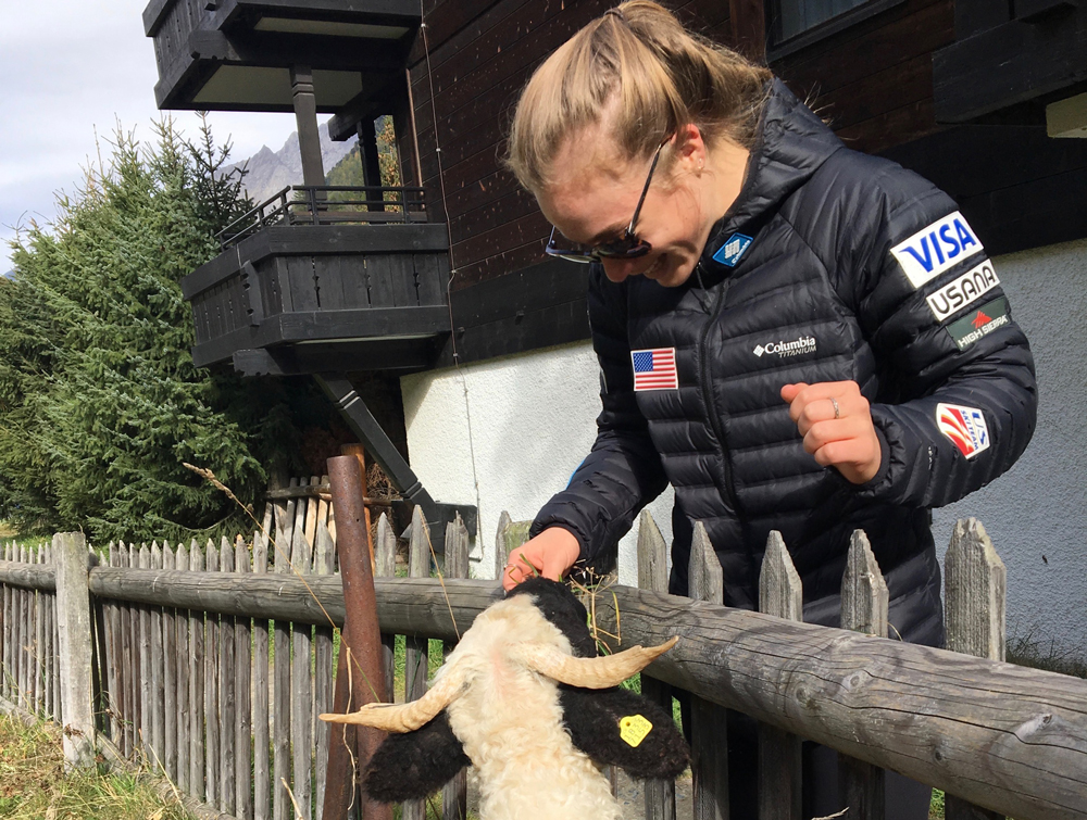Olivia Giaccio stops to pet some local sheep