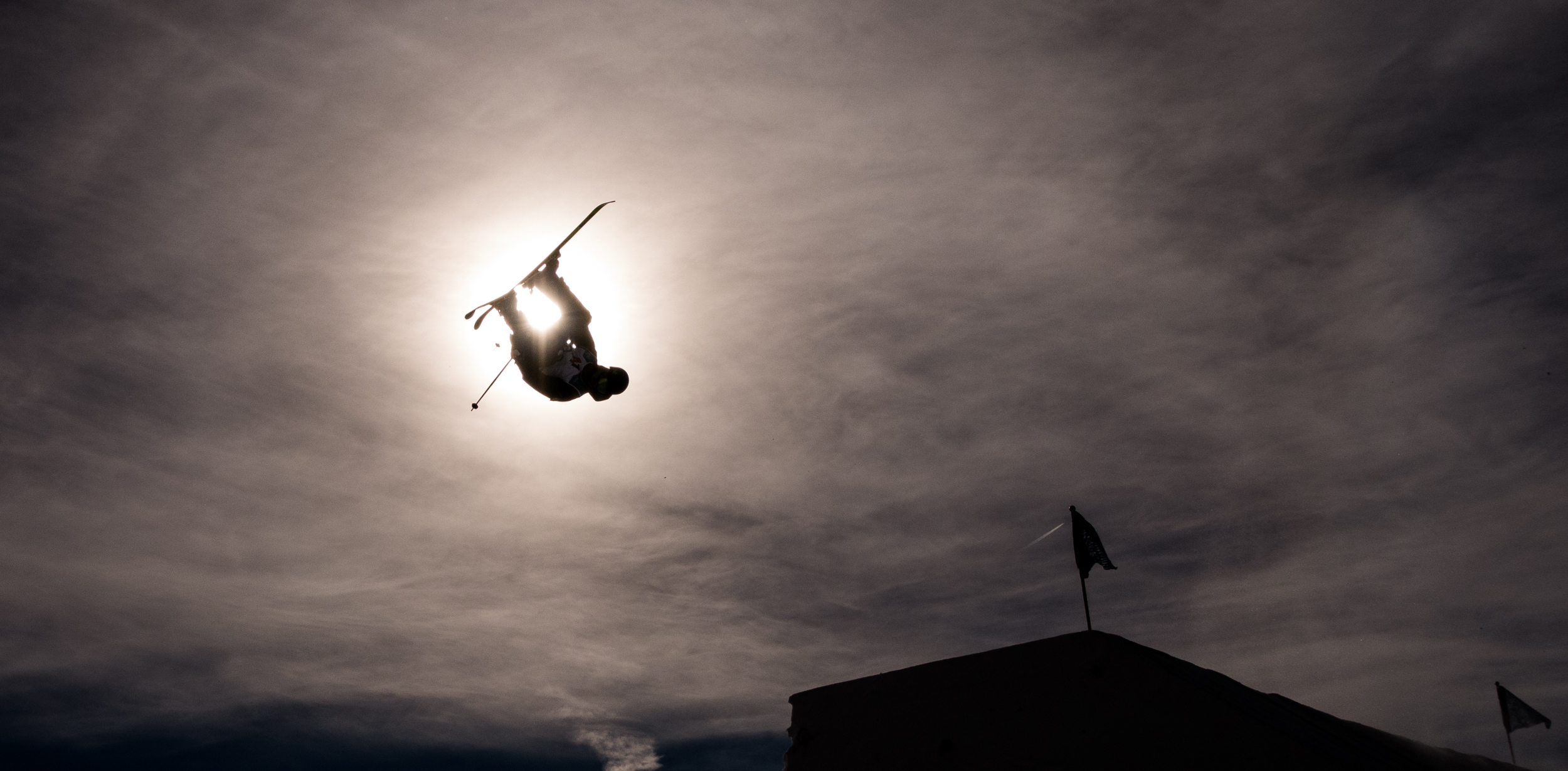 Athlete blocking the sun in Stubai, Austria. (Mateusz Kielpinski/FIS Freestyle) Athlete mid air in front of the sun in Stubai, Austria.