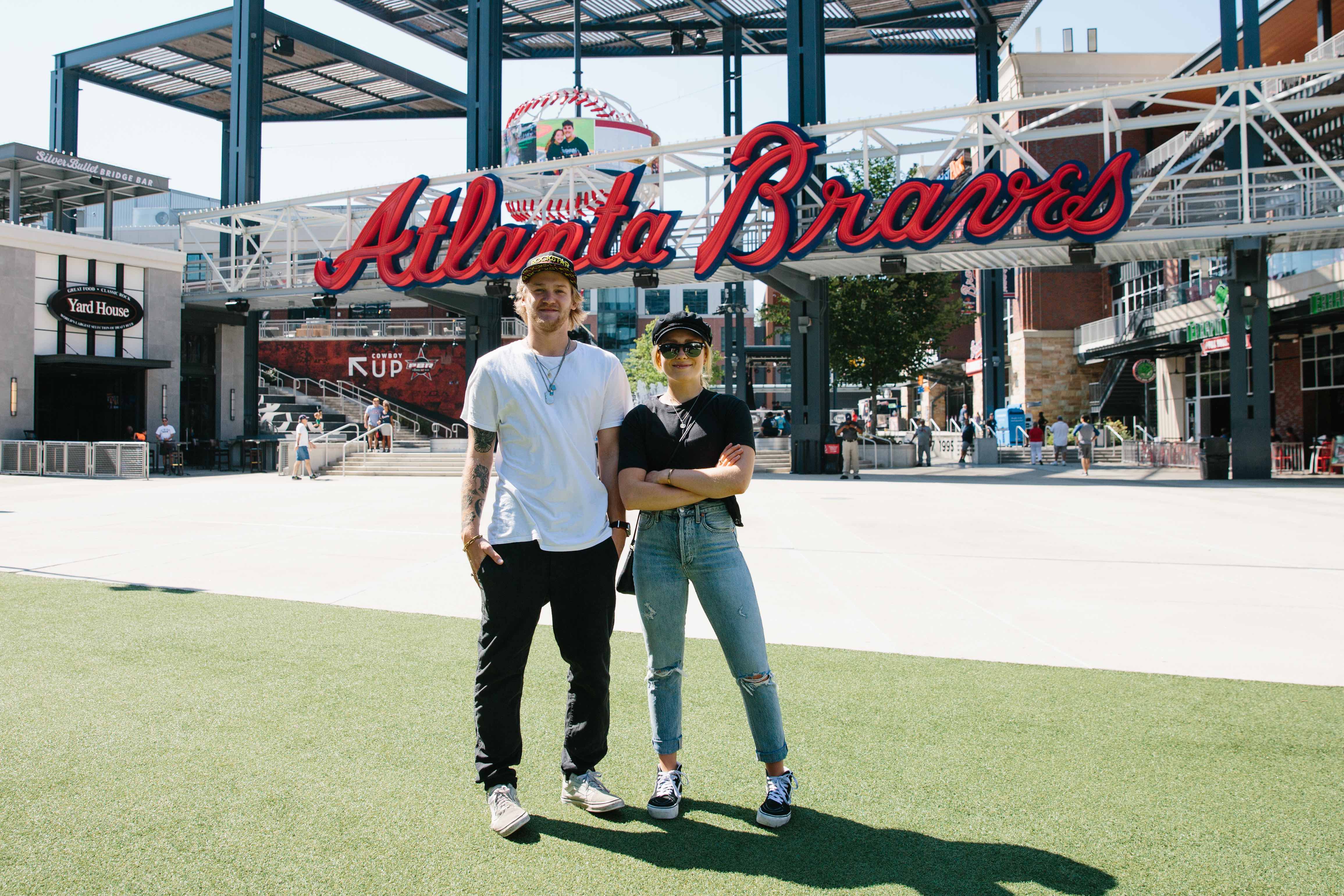 Kyle Mack and Maggie Voisin in The Battery at the Visa Big Air presented by Land Rover Announcement at SunTrust Park. (U.S. Ski & Snowboard - Sarah Brunson) maggie and kyle with braves logo