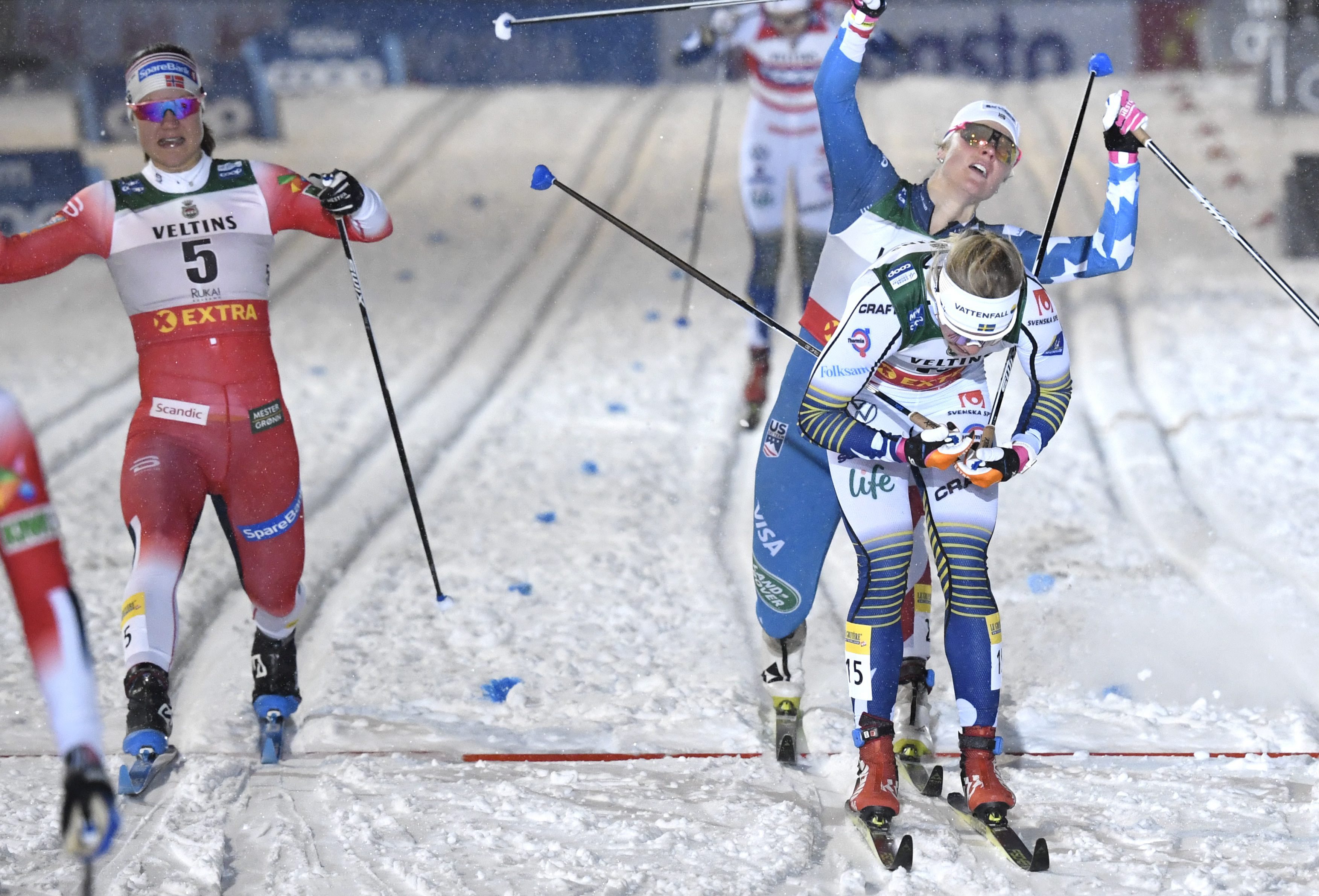 Sadie Maubet Bjornsen of the U.S. streches behind second-placed Jonna Sundling (R) of Sweden to beat Ane Appelkvist Stenseth of Norway and place third
