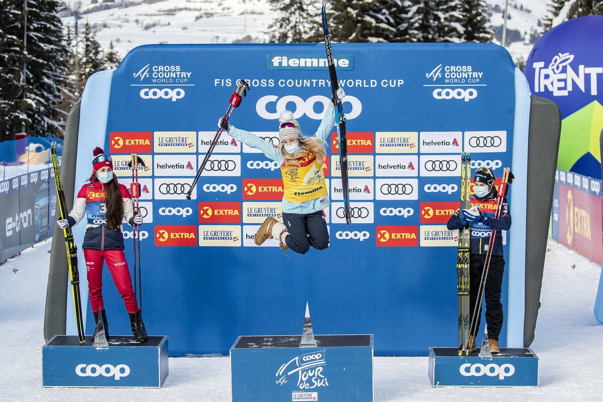 Jessie Diggins celebrates her overall Tour de Ski title with Russia's Yulia Stupak (left) in second, and Sweden's Ebba Andersson in third. (Vianney THIBAUT/NordicFocus)