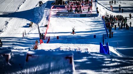 Athlete inverted on the bottom jump on Ambush mogul course