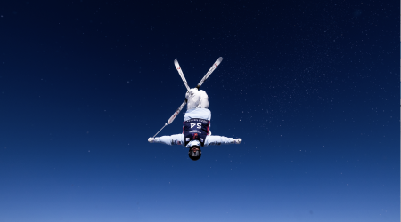 Inverted Freestyle Mogul Skier with Skis Crossed