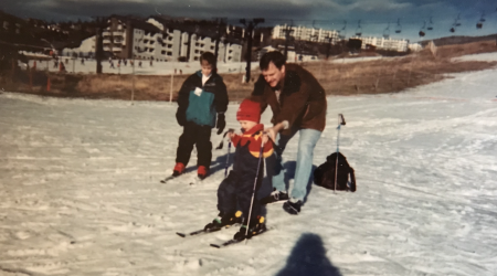 Picture of Nick, his brother, and his father skiing. 