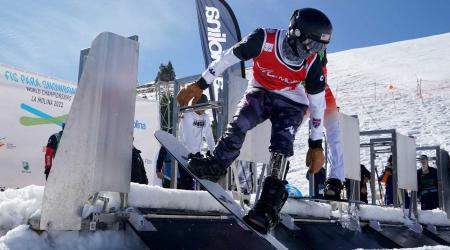 U.S. Para Snowboard athlete pushes out of the gate during a snowboardcross race