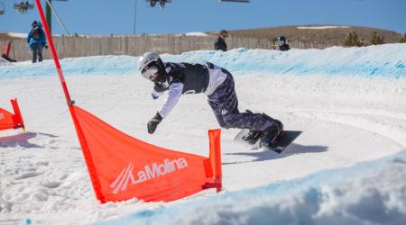 U.S. Para Snowboard athlete rounds a gate during a snowboardcross race