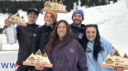 Brenna Huckaby, Kate Delson, Noah Elliott and Zach Miller smile with their awards following the podium ceremony in Grasgehren, Germany