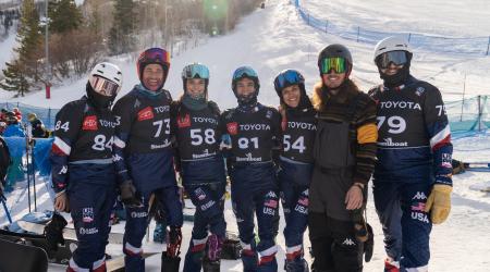 the team posing for a photo at the top of the course in steamboat springs