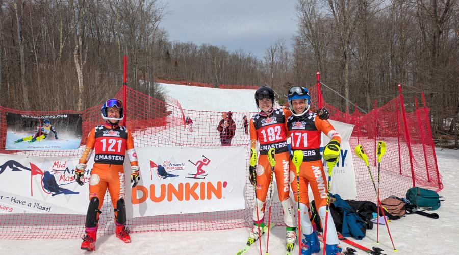 Dunkin' Sponsor Banner with  U.S. Ski &amp; Snowboard Masters racers at the 2025 Gore Nationals